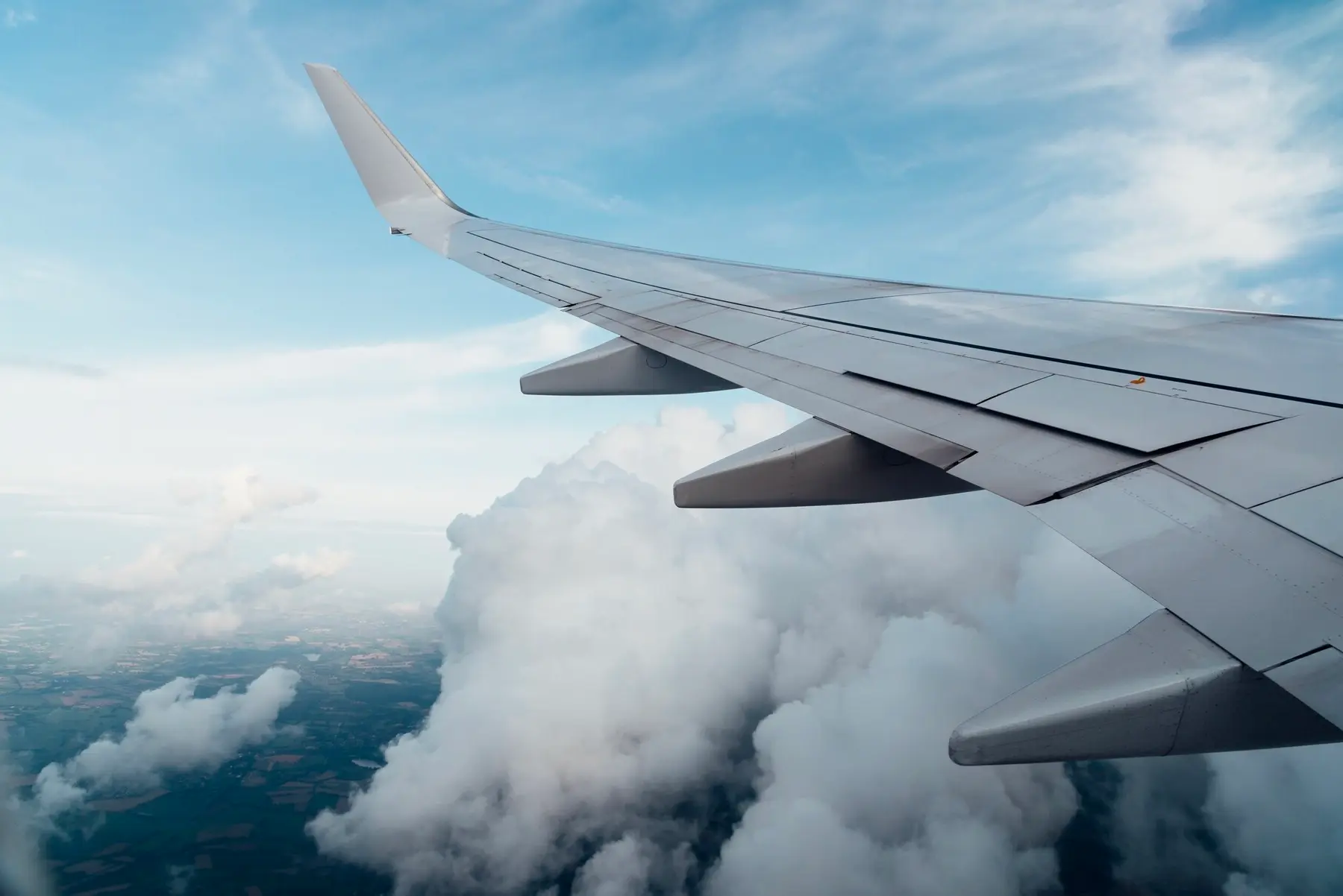 Airplane wing flying through clouds
